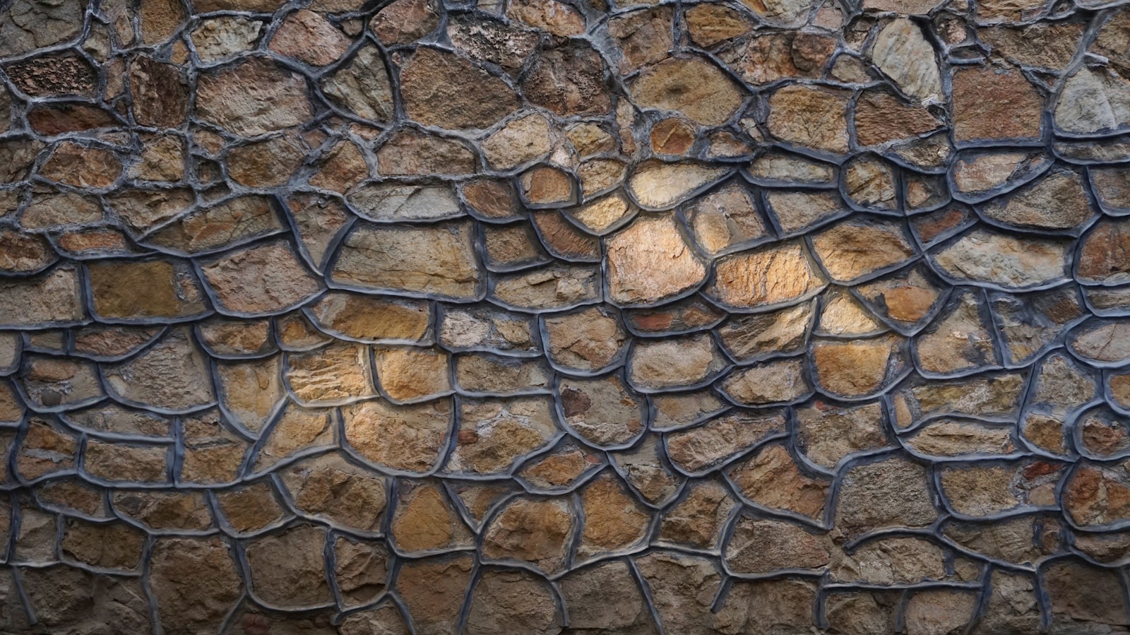 a close up of a stone wall with a metal grate